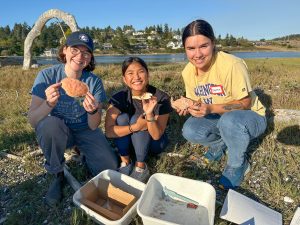 Volunteers in San Juan County smiling with their collected crab molts