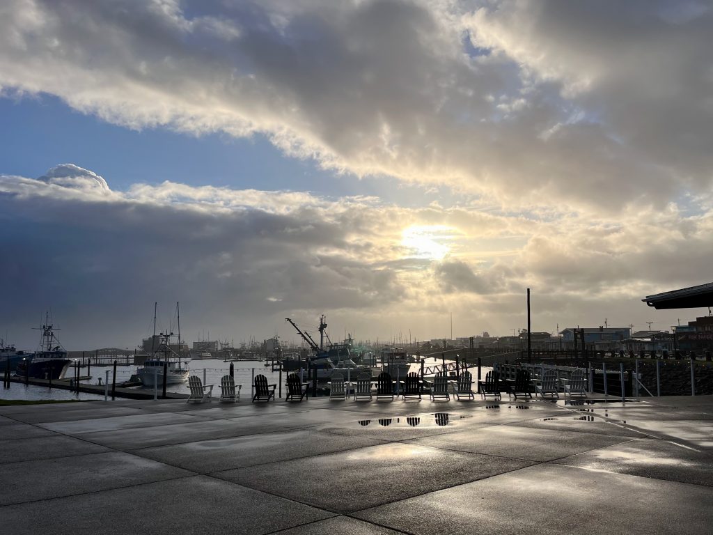 Sun breaking through clouds over Westport Marina