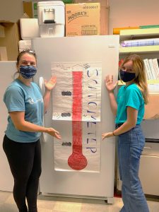 Zoë K. Lewis and Maddie Gard proudly presenting their complete “scat-o-meter” that was progressively filled in as Steller sea lion scat samples were processed for the study.