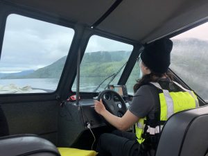 Elyse driving a boat to a sampling site in Southeast Alaska