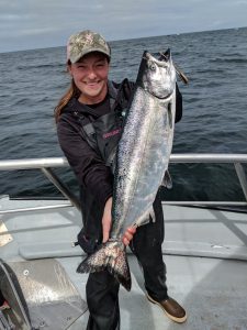 Marina holding a chinook. Photo courtesy of the City of Westport.