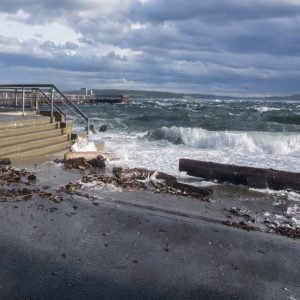 Waves pushing past boundaries onto a boardwalk in Port Townsend, WA.