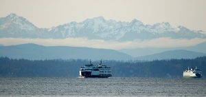 A ferry in Puget Sound in front of the olympic mountains