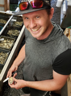 Stuart Thomas shucks oysters and smiles at the camera