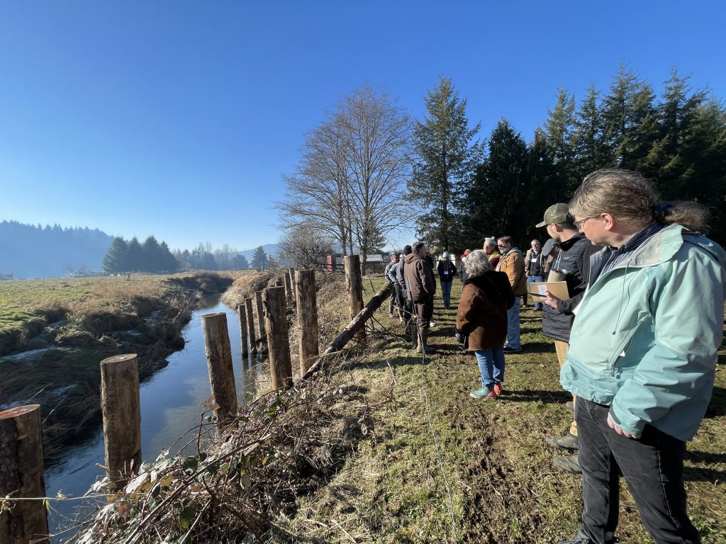 A group of people looks at a waterway