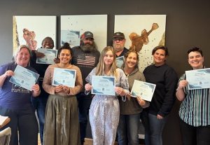 HACCP class students hold up their certificates of completion